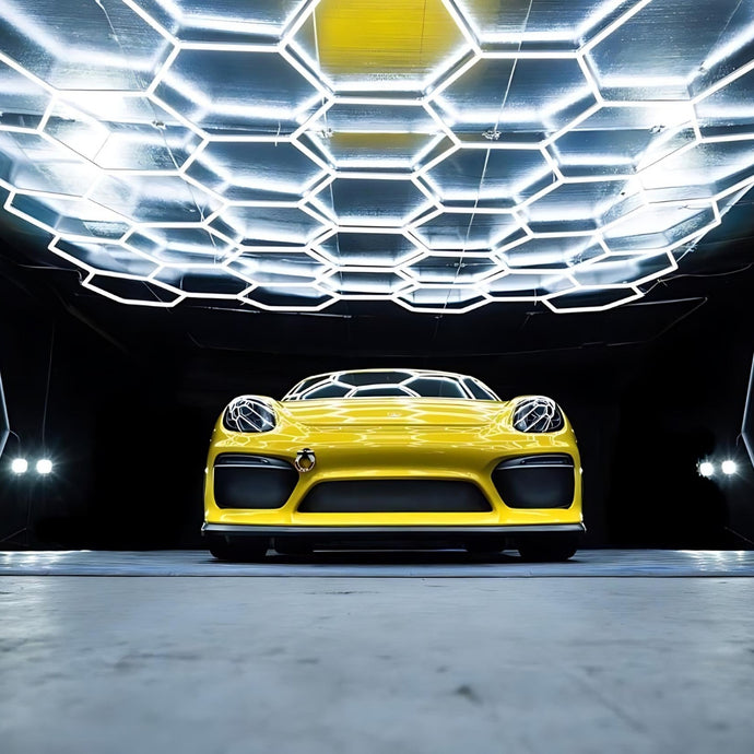 Yellow car parked under hexagon LED grid lights, with shadows cast on the car creating a dramatic effect