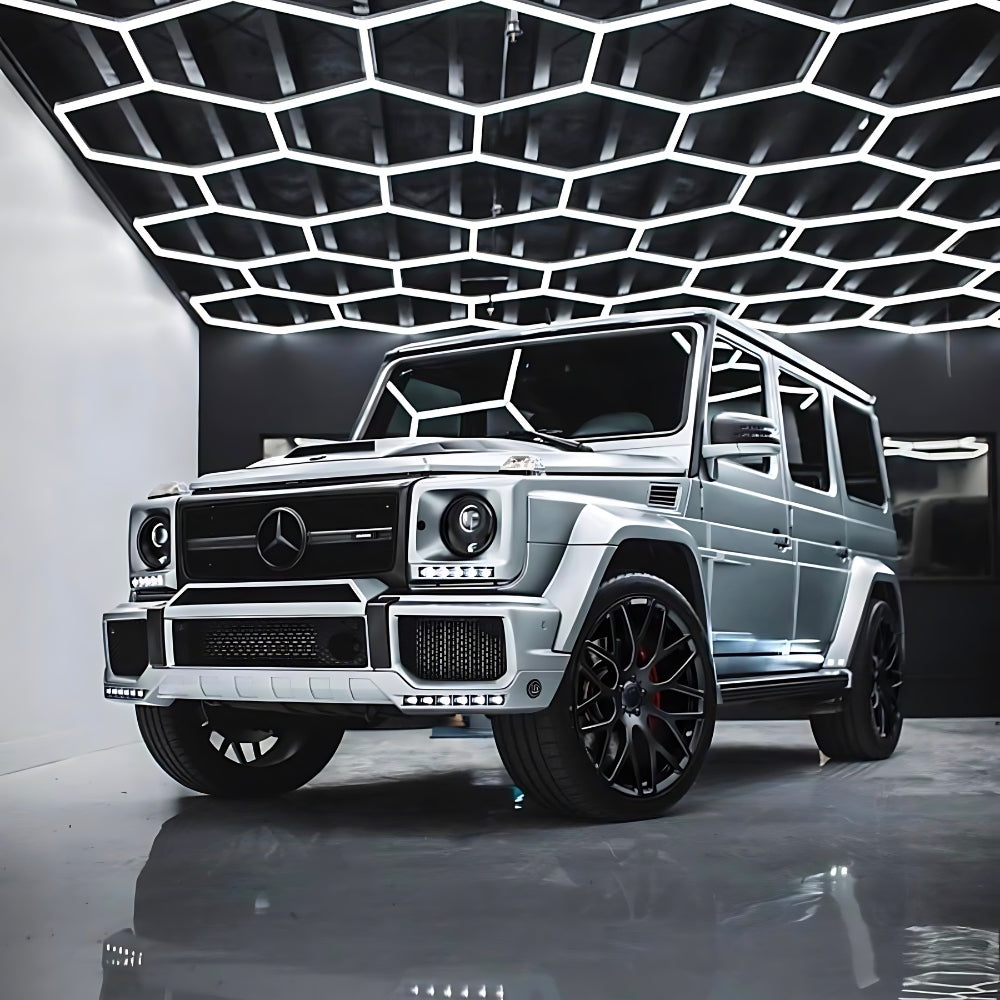 Jeep illuminated from above by a grid of hexagon LED lights, highlighting the vehicle with a modern lighting effect