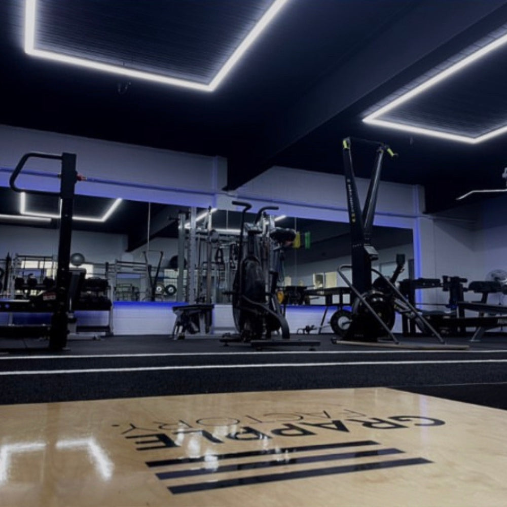 Rectangular LED lights mounted on the gym roof, providing ample and even illumination for a bright workout environment